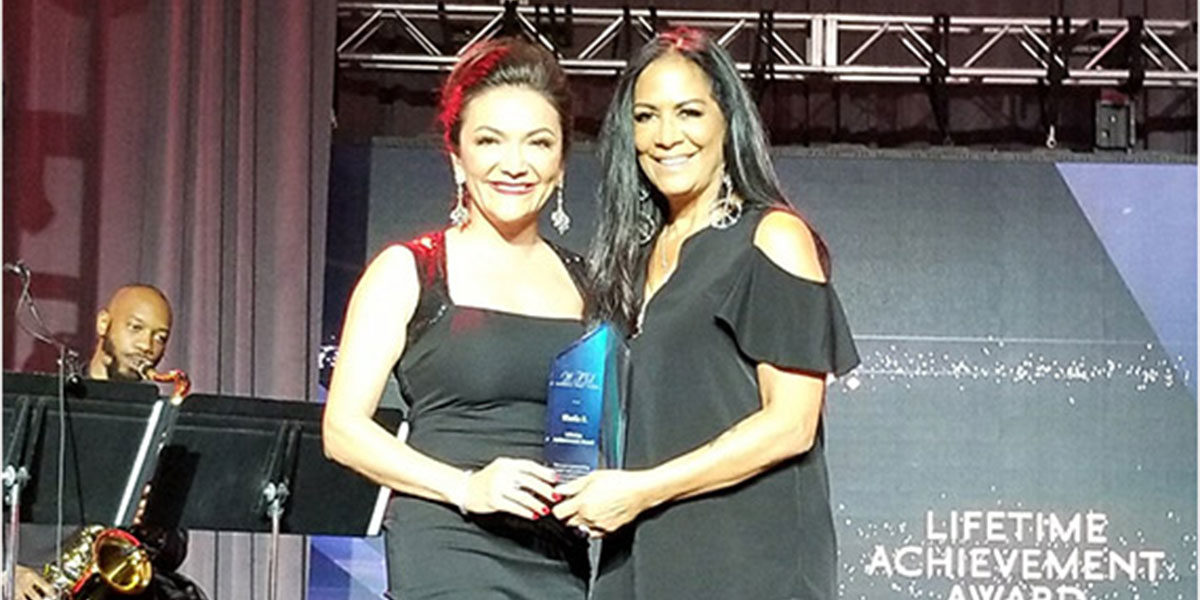 Nina Vaca presents the Lifetime Achievement Award to Sheila E.